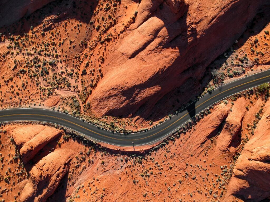 aerial photography of concrete road near rock mountain