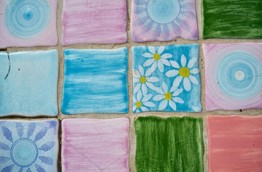 Pink and blue tiles with flowers painted on them.